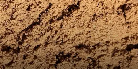 Close-up texture of fine tan screened bank sand with a lightly crumbled surface
